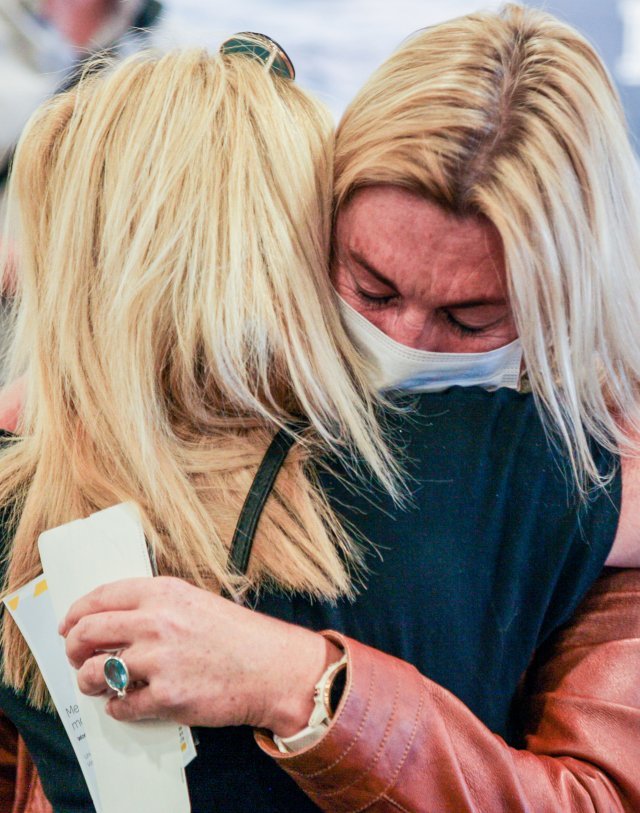 19일 호주에서 귀국한 한 승객이 뉴질랜드 크라이스트 공항에서 가족과 만나 포응하고 있다.신화=뉴시스