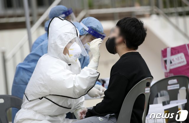 12일 오전 울산 동구 한 초등학교 운동장에 마련된 신종 코로나바이러스 감염증(코로나19) 임시 선별진료소에서 한 학생이 검사를 받고 있다. 이날 이 학교 학생 2명이 코로나19 확진 판정을 받았다. 2021.5.12/뉴스1 © News1