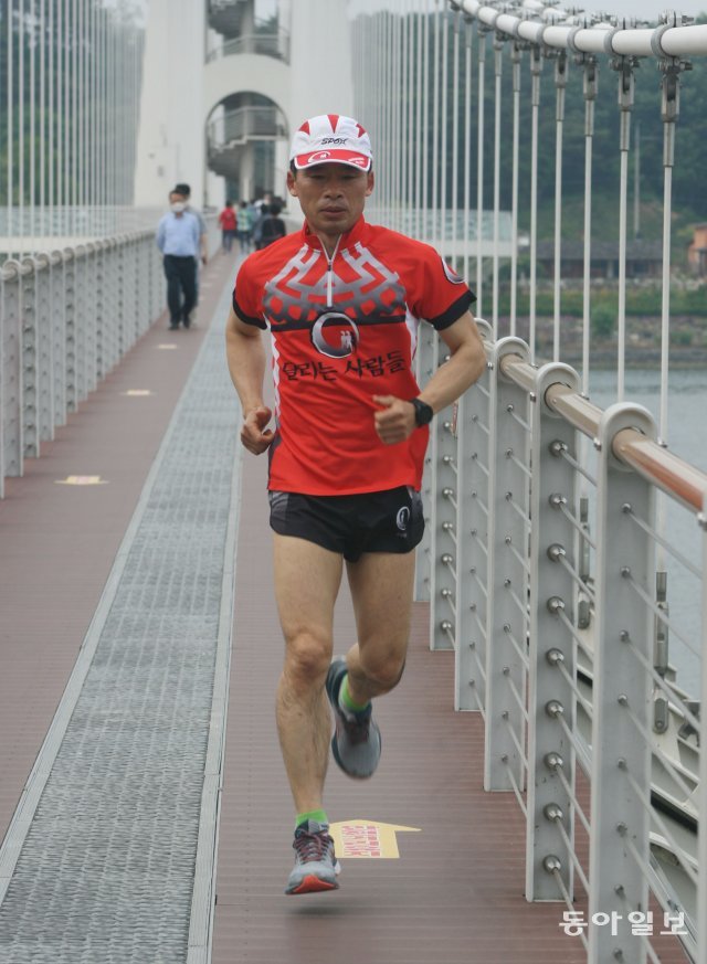 성덕제 씨가 고향인 충남 예산의 예당저수지 출렁다리를 달리고 있다. 그는 매일 새벽 10~15km를 달린 뒤 하루를 시작한다. 예산=양종구 기자 yjongk@donga.com