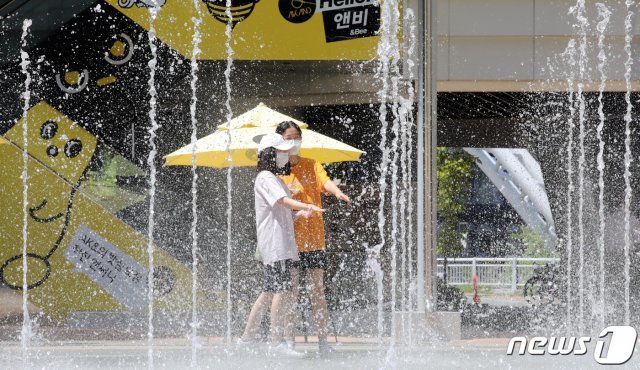 세종시에서 낮 최고기온 35℃와 체감온도 37℃를 기록하며 폭염특보가 내려진 지난 23일 세종시 어진동에 위치한 한 쇼핑몰을 찾은 학생들이 바닥분수에서 더위를 식히고 있다. 2021.7.23/뉴스1 © News1