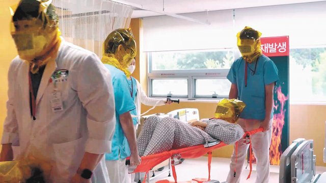 화재 모의 훈련에 참여 중인 유성선병원 의료진들이 모의 환자에게 방연 마스크를 씌우고 들것에 실은 뒤 안전한 장소로 이동하고 있다. 선병원재단 제공