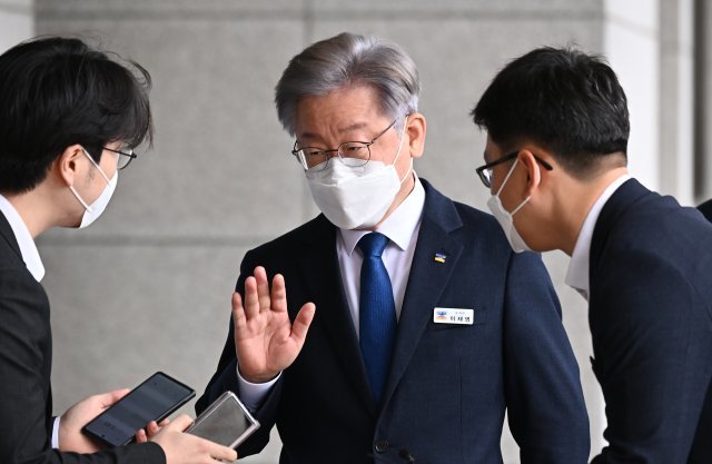 더불어민주당 제20대 대통령후보로 선출된 이재명 경기도지사가 12일 오전 경기도 수원시 경기도의회에서 열린 제355회 임시회 제2차 본회의에 출석하기 위해 이동하고 있다. 취재진이 질문을 하자 답변하지 않은채 손을 들어보이고 있다. 사진공동취재단