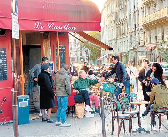 지난달 28일(현지 시간) 프랑스 파리 ‘르카리용’ 카페의 야외 테라스에서 여유를 즐기고 있는 파리 시민들. 2015년 11월 테러 당시 이곳에서만 10명이 숨졌다. 파리=김윤종 특파원 zozo@donga.com