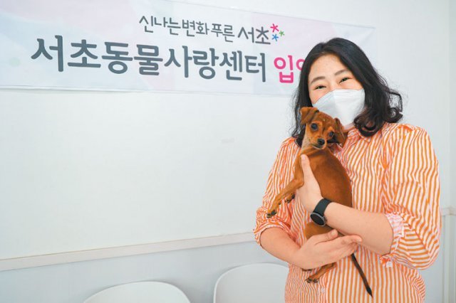 지난달 21일 서울 서초동물사랑센터에서 입양자 이미혜 씨가 새로운 가족으로 맞이한 유기견 ‘콜라’를 안고 활짝 웃고 있다. 서초구 제공