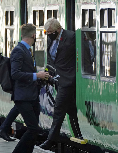 제26차 유엔기후변화협약 당사국총회(COP26) 참석을 위해 10일 영국 런던에서 기차를 타고 글래스고로 이동한 보리스 존슨 영국 총리가 글래스고 중앙역에 도착해 기차에서 내리고 있다.  글래스고=AP 뉴시스
