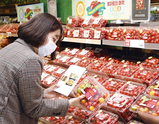 이마트 성수점에서 고객이 토마토를 살펴보고 있다.