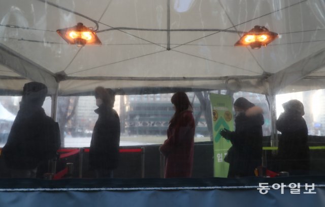 서울 시청광장에 마련된 코로나19 임시선별 검사소. 시민들이 난로 아래에서 검사순서를 기다리고 있다. 김재명 기자 base@donga.com