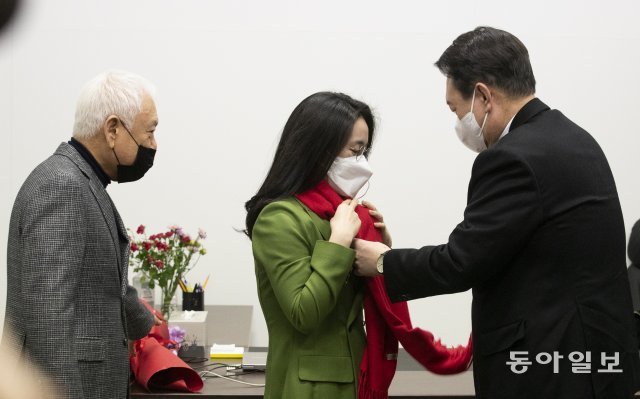 국민의힘 윤석열 대선 후보(오른쪽)가 20일 서울 여의도에 위치한 국민의힘 새시대준비위원회 위원장실에서 영입인사 환영식을 열고 신지예 한국여성정치네트워크 대표에게 환영의 목도리를 걸어주고 있다. 왼쪽은 김한길 새시대준비위원장. 원대연 기자 yeon72@donga.com