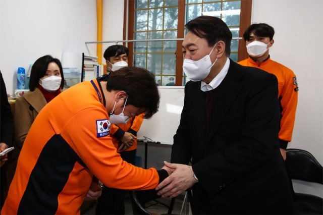 국민의힘 윤석열 대선 후보(오른쪽)가 지난 20일 코로나19 확진 판정을 받은 임산부를 호송하다 구급차에서 출산을 도운 경기도 양주 광적119안전센터를 방문해 구급대원들과 인사하고 있다. 사진공동취재단