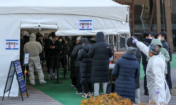 27일 오전 서울 송파구보건소에 마련된 신종 코로나바이러스 감염증 선별검사소를 찾은 시민들이 길게 줄을 서 차례를 기다리고 있다. 2021.12.27/뉴스1 © News1