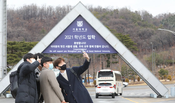 서울 관악구 서울대학교 정문 앞에서 기념사진을 찍는 신입새들. 뉴스1