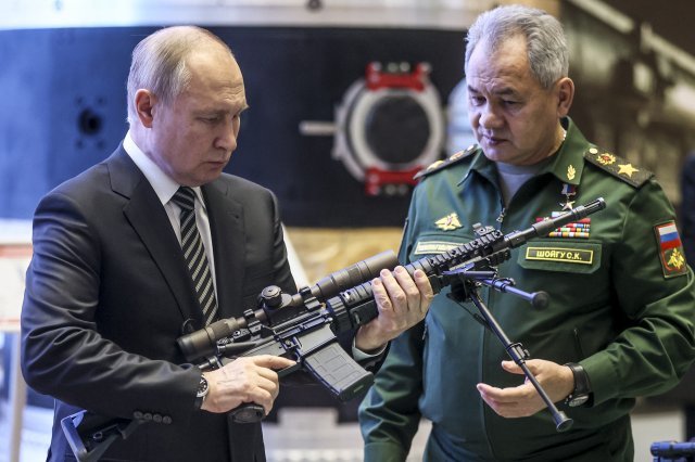 지난해 12월 21일 블라디미르 푸틴 러시아 대통령(왼쪽)이 모스크바에 있는 군사장비 전시장에서 저격용 소총을 든 채 살펴보고 있다. 푸틴 대통령 옆은 세르게이 쇼이구 국방장관. 푸틴 대통령은 이날 우크라이나의 북대서양조약기구(NATO) 가입 추진과 관련해 우크라이나의 서방 밀착, 러시아에 대한 서방의 견제가 계속되면 군사 대응도 불사하겠다고 밝혔다. 모스크바=AP 뉴시스