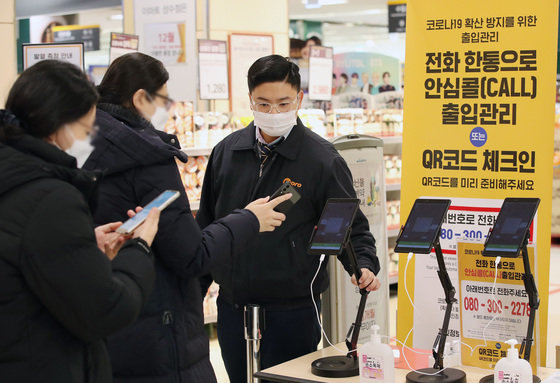 서울 시내의 한 대형마트에서 고객들이 QR코드를 체크한 뒤 입장하고 있다.2021.12.31/뉴스1 © News1