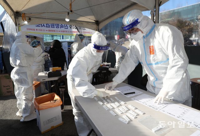 서울역광장에 마련된 코로나19 신속항원검사소에서 의료진이 자가진단키트를 살펴보고 있다.