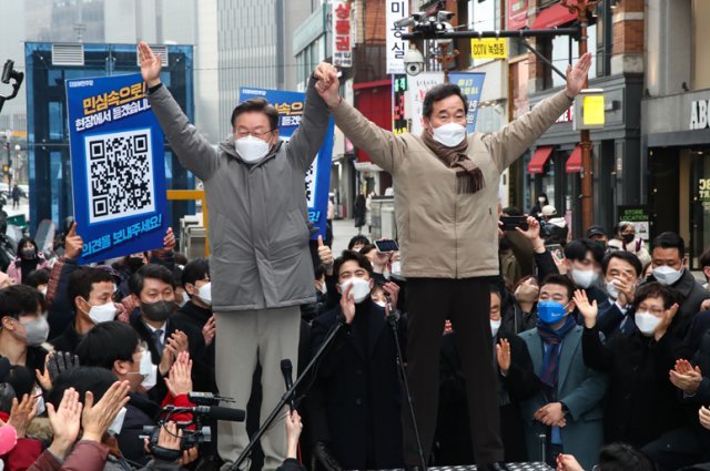 더불어민주당 이재명 대선 후보(왼쪽)와 이낙연 전 대표가 지난 1월 25일 오후 경기 의정부시 행복로 시민광장에서 손을 맞잡고 인사를 하고 있다.  의정부=사진공동취재단