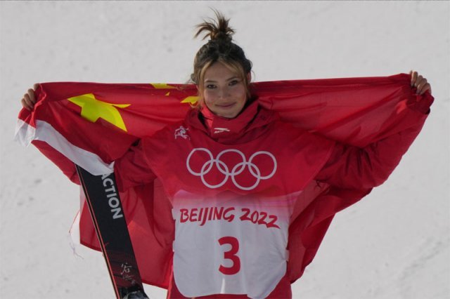 아일린 구가 15일 중국 장자커우 윈딩 스노파크에서 열린 2022 베이징 겨울올림픽 여자 프리스타일 스키 슬로프스타일에서 은메달을 딴 뒤 중국 국기를 펼쳐든 채 세리머니를 선보이고 있다. 빅에어 금메달에 이어 2개 종목 메달 획득에 성공한 구는 하프파이프까지 프리스타일 스키 3개 전 종목 메달에 도전한다. 구의 활약이 이어질수록 중국에서는 이중 국적 유지 등 그가 예외적으로 받는 특혜에 대한 비판도 이어지고 있다. 베이징=AP 뉴시스