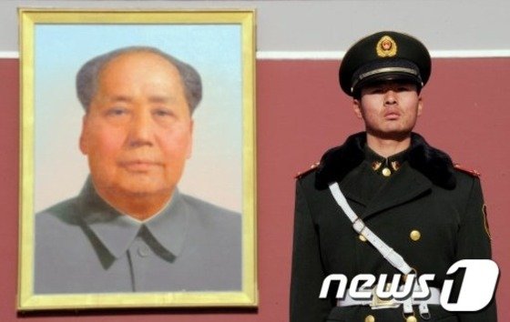 중국 베이징 천안문 광장의 마오쩌둥 초상화 앞에 서 있는 한 중국 군인. © AFP=뉴스1