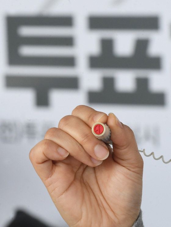 제20대 대통령 선거 사전투표를 하루 앞둔 3일 서울역에 마련된 남영동사전투표소에서 서울시 선거관리위원회 관계자가 기표도장을 들어보이고 있다. 뉴스1