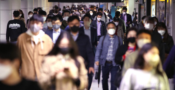 29일 오전 서울 시청역에서 마스크 쓴 시민들이 출근길 발걸음을 옮기고 있다. 이날 정부는 다음 달 2일부터 실외 마스크 착용 의무를 해제한다고 밝혔다. 2022.4.29/뉴스1 © News1