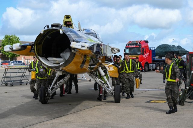 블랙이글스의 정비사들이 영국 보스콤브다운 기지에 도착한 T-50B 항공기를 격납고로 운반하고 있다. (공군 제공)