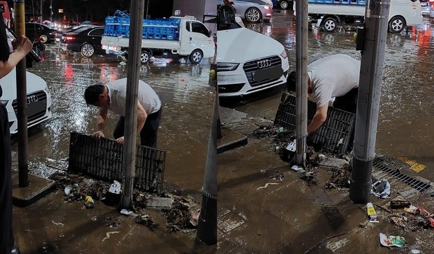 서울 강남역에서 맨손으로 배수구를 막은 쓰레기를 치우는 남성 시민. (온라인 커뮤니티 갈무리) ⓒ 뉴스1