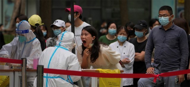 지난 4월 중국 베이징 차오양구 주상복합건물 인근에서 시민들이 신종 코로나바이러스 감염증(코로나19) 유전자증폭(PCR) 검사를 받고 있다. 베이징=AP 뉴시스