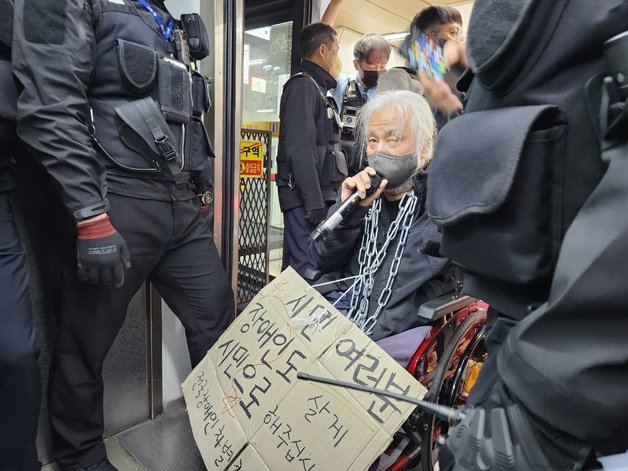 박경석 전장연 공동대표 25일 장애인권리예산 반영을 촉구하며 지하철에서 집회를 하고 있다. 뉴스1