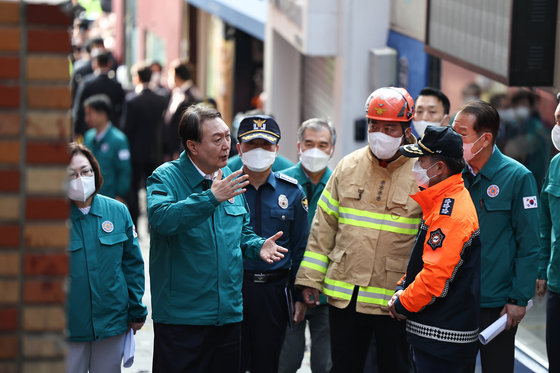 윤석열 대통령이 30일 오전 서울 용산구 이태원 핼러윈 압사사고 현장을 찾아 참사 현장을 살펴보며 소방 관계자들과 대화하고 있다. 대통령실 제공