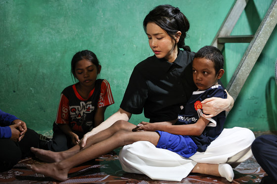윤석열 대통령 부인 김건희 여사가 지난달 12일 캄보디아 프놈펜에서 선천성 심장질환을 앓고 있는 14세 아동의 집을 찾아 아이를 안고 있다. 대통령실 제공 2022.11.13