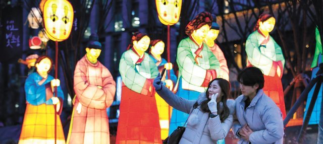 서울 종로구 광화문광장에서 시민들이 빛 조형물을 배경으로 사진을 찍고 있다. 시가 연말까지 빛 조형물과 미디어아트를 활용한 행사를 열면서 광화문광장이 ‘야경 핫플(핫플레이스)’로 떠오르고 있다. 뉴스1