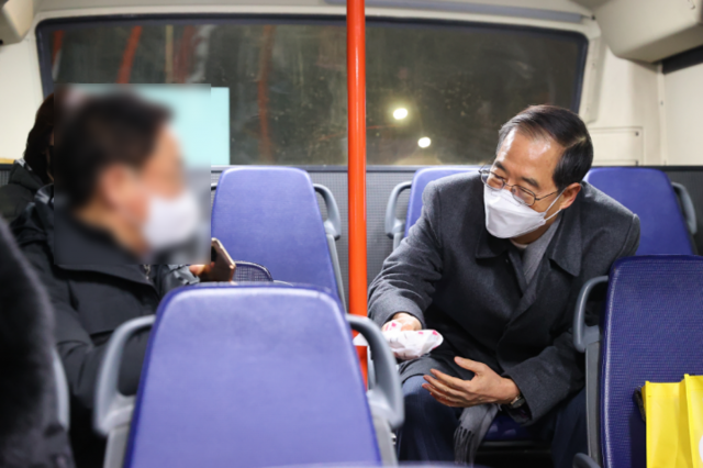 한 총리가 146번 버스에 탑승한 승객에게 토끼 모양으로 포장된 핫팩을 건네고 있다. 사진제공=국무총리비서실