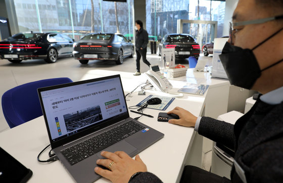 서울의 한 자동차 판매지점에서 개별소비세 관련 기사를 보고 있는 직원의 모습. 2022.12.28/뉴스1DB