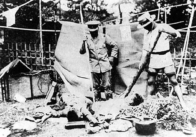 1923년 간토대학살 당시 일본 자경단원들이 학살당한 조선인의 시체를 내려다보고 있다. 동아일보DB