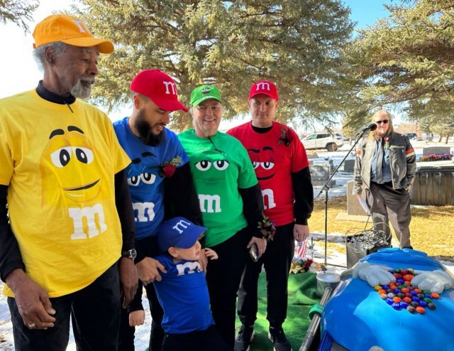 The family at Mary's funeral wearing M&Ms hats and T-shirts.  roundtree scott tick tock