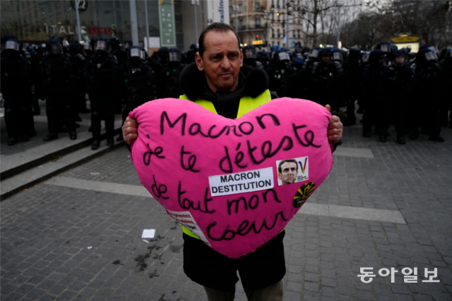 7일 파리의 시위 참가자가 ‘마크롱 극혐’이라고 적힌 쿠션을 들고 있다. 파리=AP 뉴시스