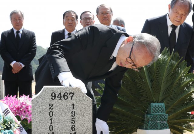 이명박 전 대통령이 서해수호의 날을 앞두고 22일 대전 유성구 국립대전현충원을 찾아 고(故) 한주호 준위 묘역에 참배한 뒤 묘비를 어루만지고 있다. 뉴스1