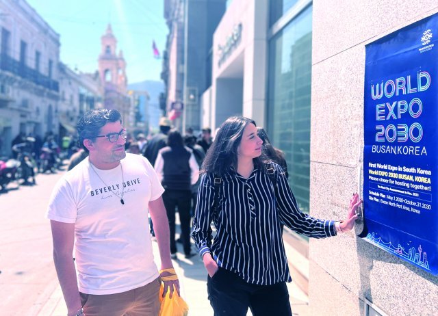 Tourists look at the poster promoting the Busan expo installed by POSCO at the Historical Museum of the North near a plaza in Salta, Argentina.  Photo by POSCO Group