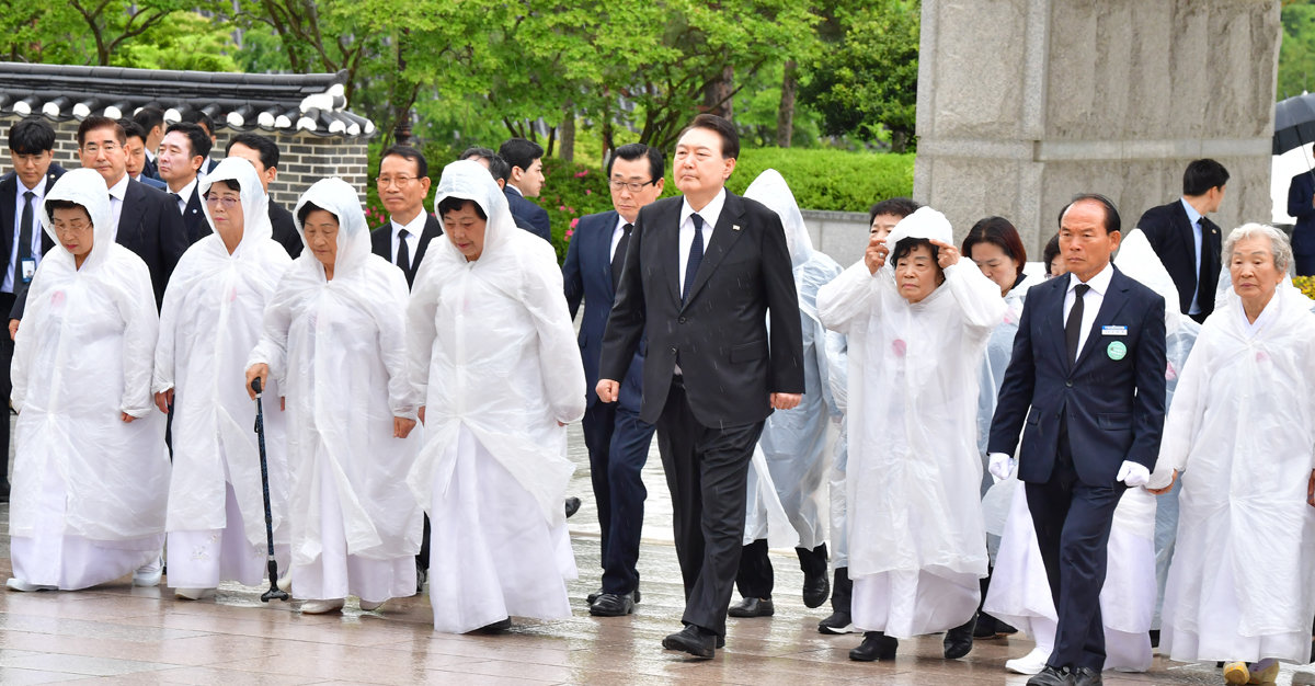 윤석열 대통령이 18일 광주 북구 국립5·18민주묘지에서 열린 5·18민주화운동 43주년 기념식에서 오월 어머니회원들과 함께 행사장으로 입장하고 있다. 대통령실사진기자단