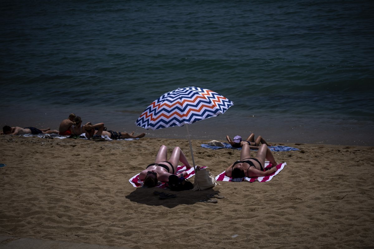 17일 스페인 바르셀로나의 한 해변에서 사람들이 일광욕을 즐기고 있다. 바르셀로나=AP 뉴시스