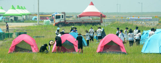 2023 새만금 세계스카우트 잼버리 개막일인 1일 전북 부안군 잼버리 야영장에서 대회 참가 대원들이 야영 준비를 하고 있다. 참가자들은 풀, 모기, 더위, 시원한 물이 부족하는 등 어려움을 호소했다. ⓒ News1