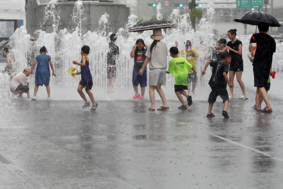 서울 지역에 강한 소나기가 내린 6일 오후 서울 종로구 광화문광장 분수대에서 어린이들이 물놀이를 하고 있다. 뉴스1