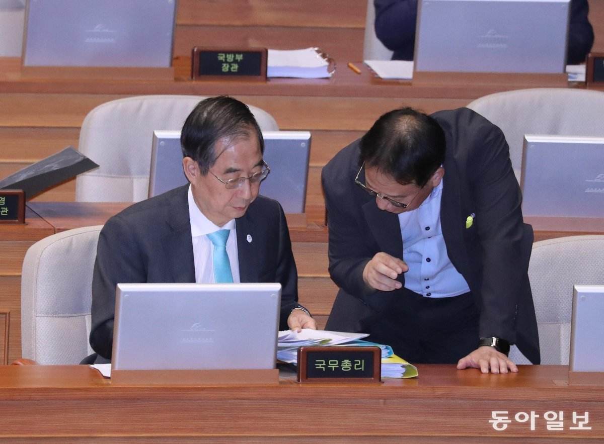 한덕수 국무총리(왼쪽)가 8일 국회 본회의장에서 열린 교육 사회 문화 분야 대정부질문에 참석해 자료를 살펴보고 있다. 이날 한 
총리는 더불어민주당 안민석 의원이 “윤석열 대통령에게 야당 대표를 만나보라고 한 적 있느냐”고 질의하자 이재명 대표의 사법 
리스크를 언급하며 “여건이 안 된다”고 답했다. 이훈구 기자 ufo@donga.com