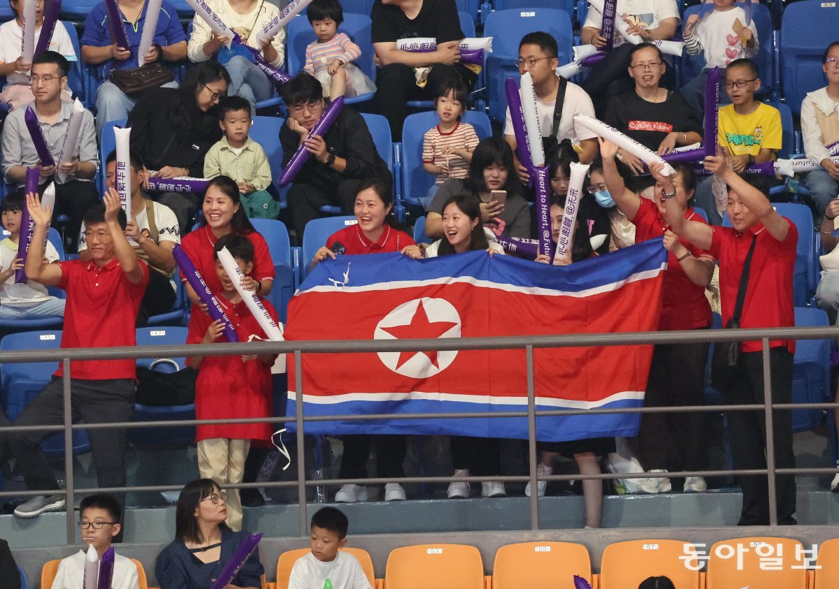 유도경기장을 찾은 북한 응원단이 인공기를 들고 환호하고 있다. 항저우=김재명 기자 base@donga.com