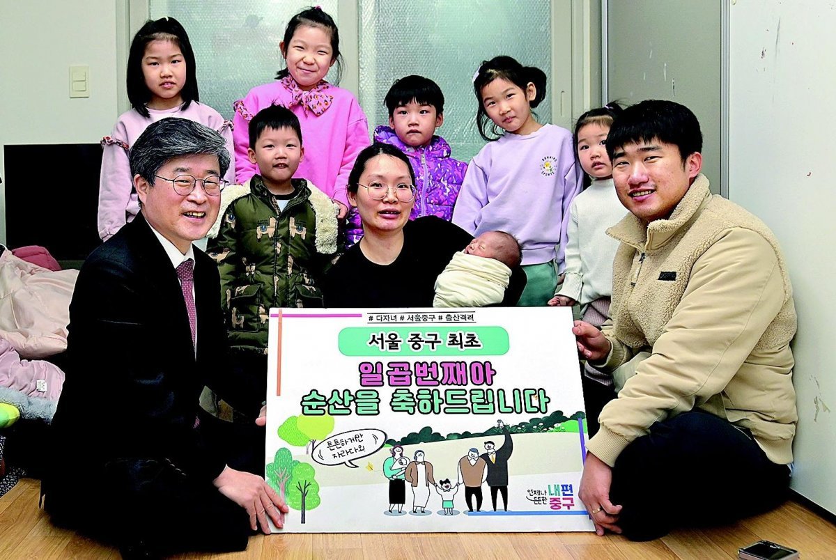 서울 중구에서 이달 일곱 번째 아이를 출산한 전혜희(가운데), 조용석(오른쪽) 부부가 자택으로 방문한 김길성 중구청장(왼쪽)의 축하를 받고 있다. 서울 중구 제공