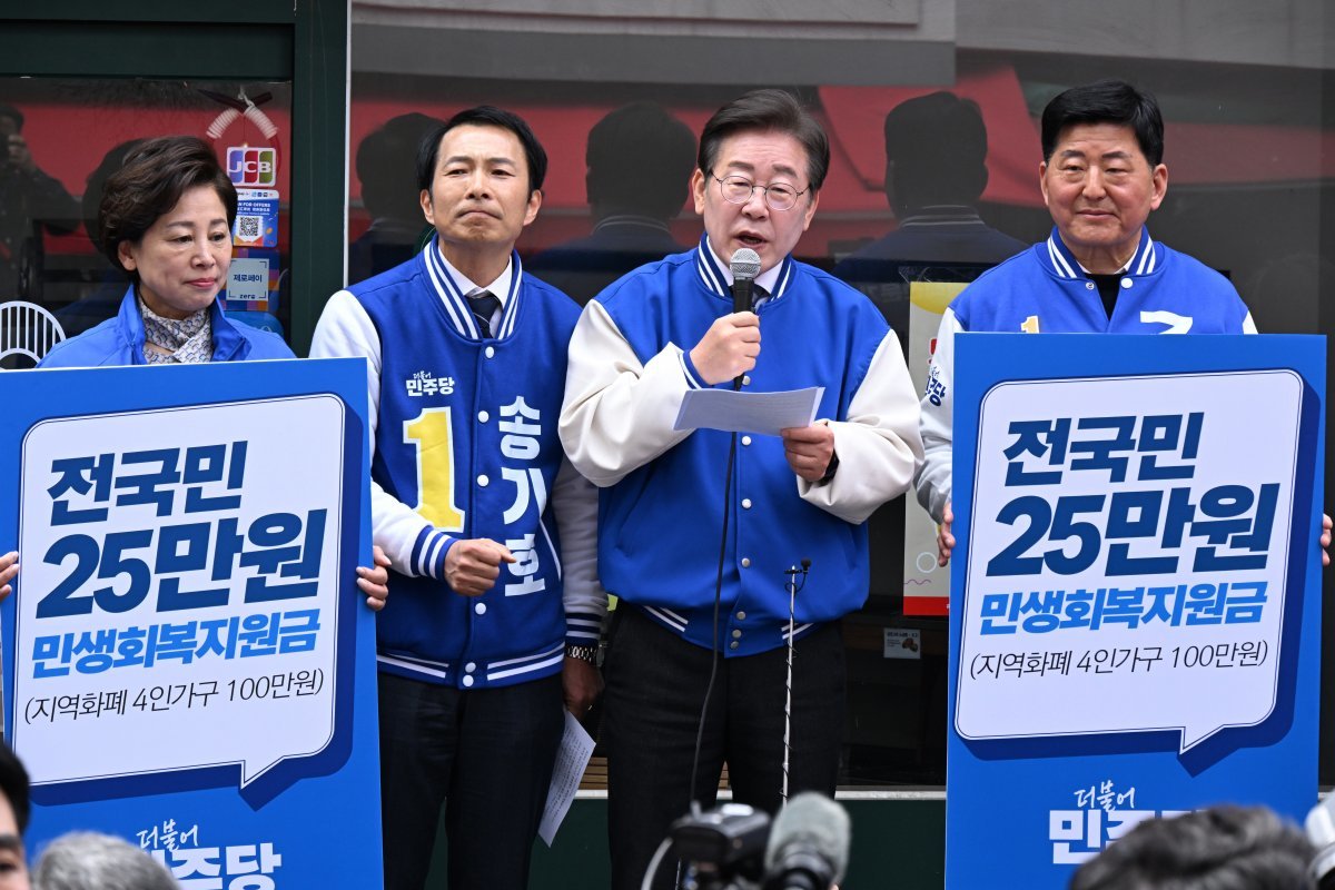 더불어민주당 이재명 대표가 24일 서울 송파구 잠실동 새마을전통시장에서 기자회견을 열고 전국민에게 25만 원씩 민생회복지원금으로 지급하겠다는 공약을 발표하고 있다. 뉴스1