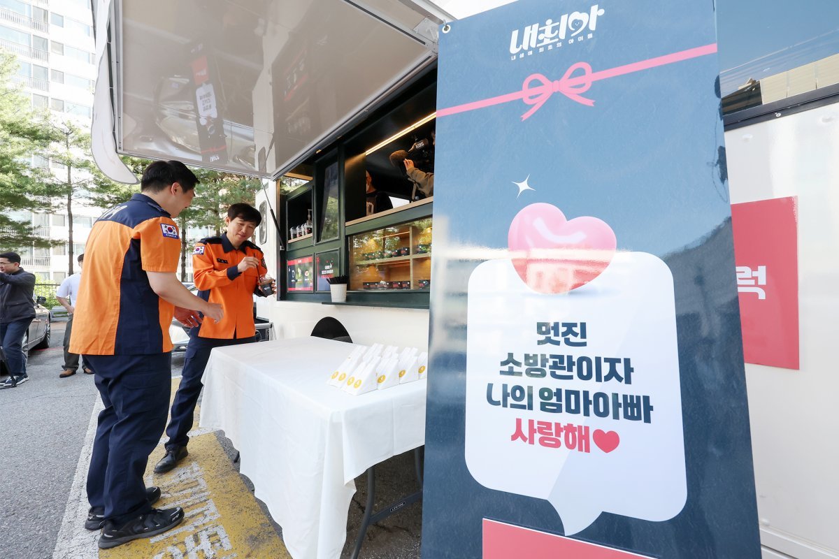 박건기 소방위가 8일 오전 서울 동작소방서에서 고3 딸 지안 양이 어버이 날을 맞아 보낸 커피차를 선물 받고 동료들에게 커피와 샌드위치를 나눠주고 있다. 2024.5.8/뉴스1