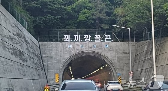 부산 도시고속도로 대연터널 위에 ‘설치된 꾀·끼·깡·꼴·끈’ 문구의 구조물. (온라인 커뮤니티 갈무리)