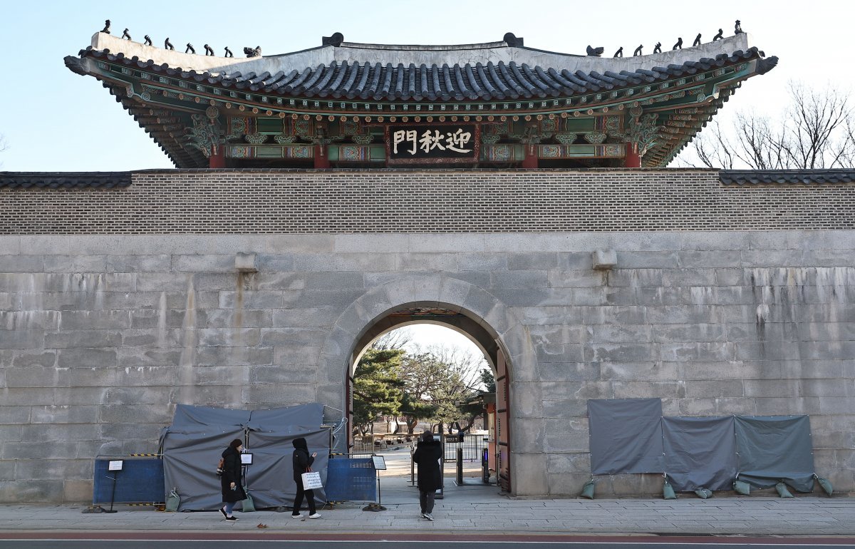 스프레이 낙서로 훼손된 서울 종로구 경복궁 영추문 담장에 17일 임시가림막이 설치돼 있다.