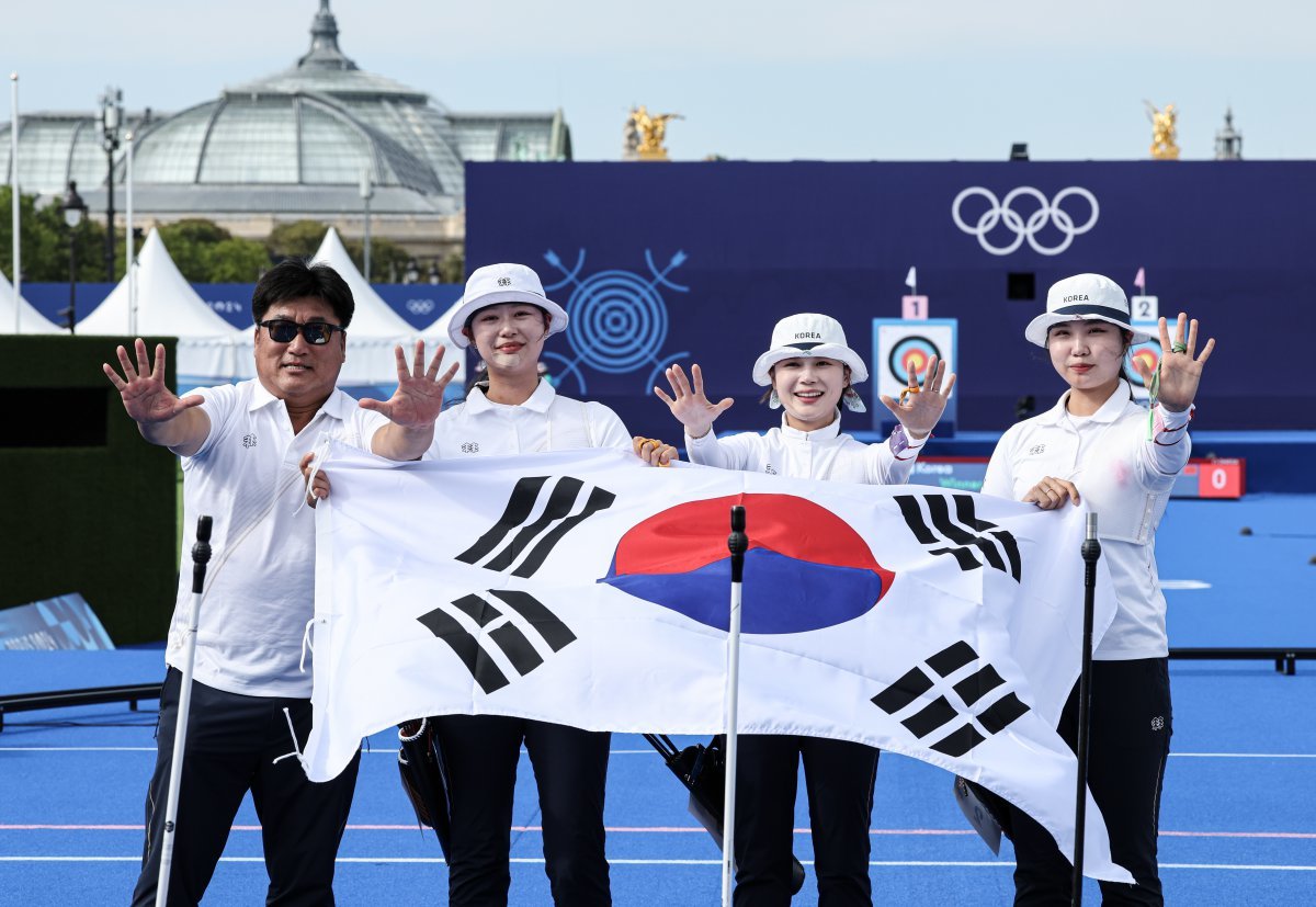 대한민국 양궁대표팀 임시현, 남수현, 전훈영, 양창훈 감독이 29일(한국시간) 프랑스 파리 레쟁발리드 특설 사로에서 열린 2024 파리올림픽 양궁 여자 단체전 중국과의 결승전에서 금메달을 획득한 후 태극기를 들어보이고 있다. 2024.7.29/뉴스1