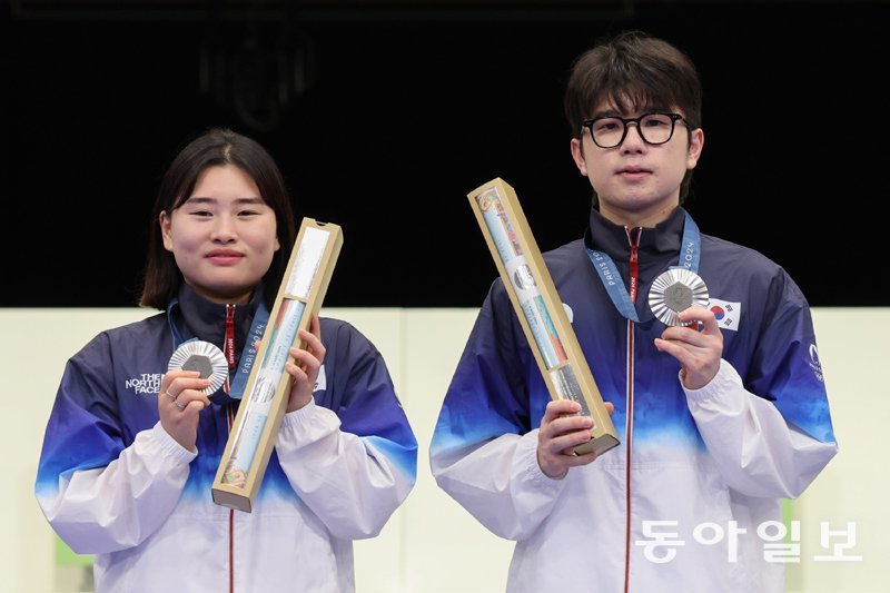 박하준-금지현 ‘한국 첫 메달’ 27일 파리 올림픽 사격 공기소총 10m 혼성 경기에서 한국 선수단 첫 메달을 따낸 금지현(왼쪽)과 박하준이 은메달을 들어 보이고 있다. 파리=양회성 기자 yohan@donga.com